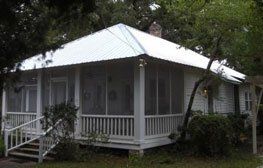 White house with outside ladder | Spanish Fort, AL | Gafford Roofing Repair