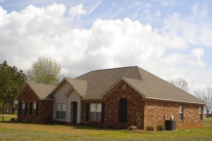 House with clouds | Spanish Fort, AL | Gafford Roofing Repair