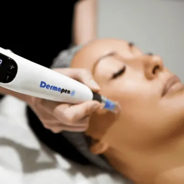A facial treatment device being used on a person’s cheek during a skincare procedure