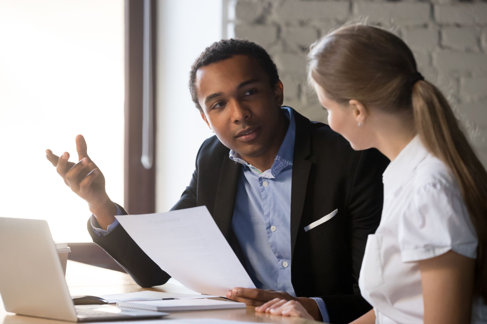 Man in suit discussing documents