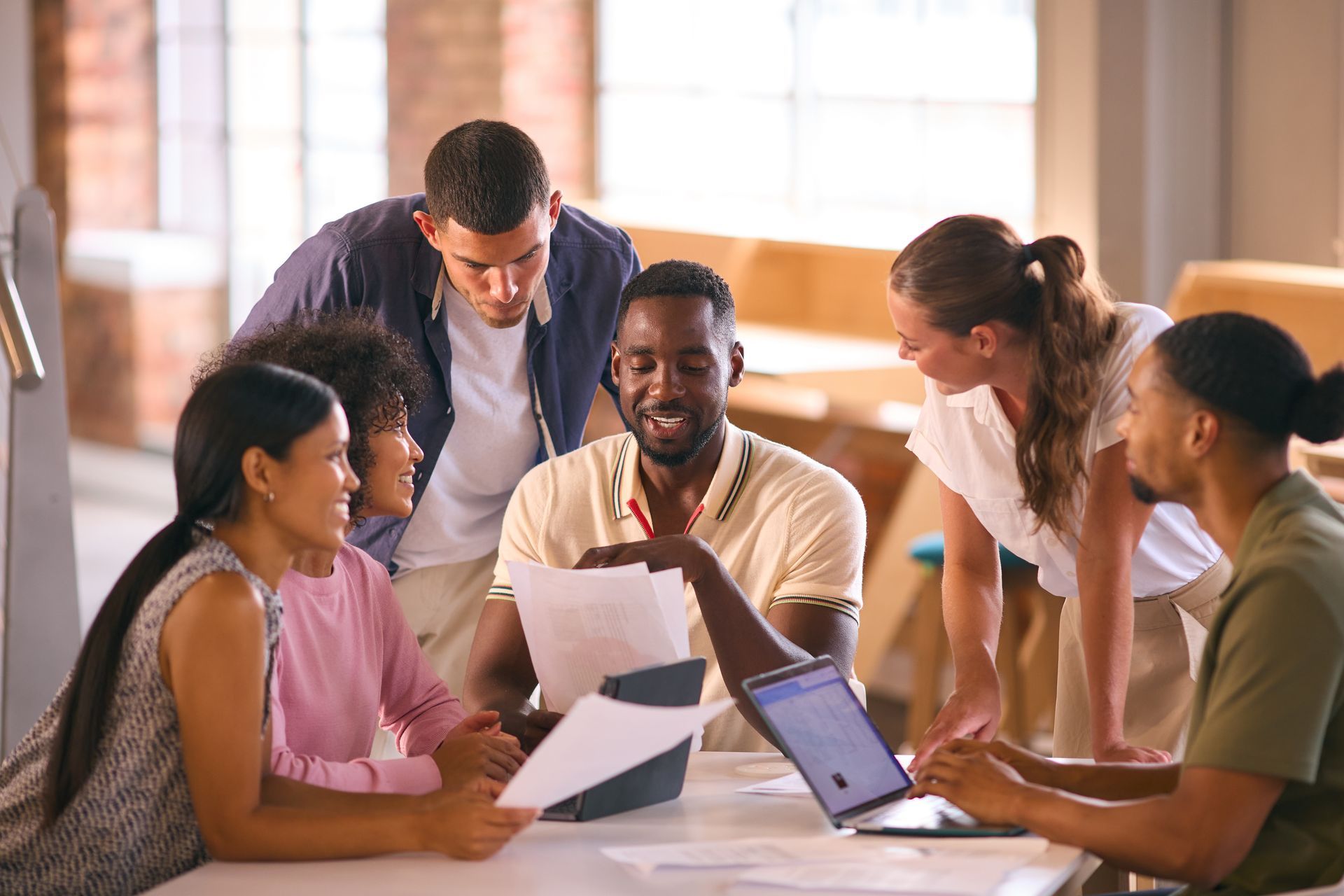 A diverse group of people collaborating around a table