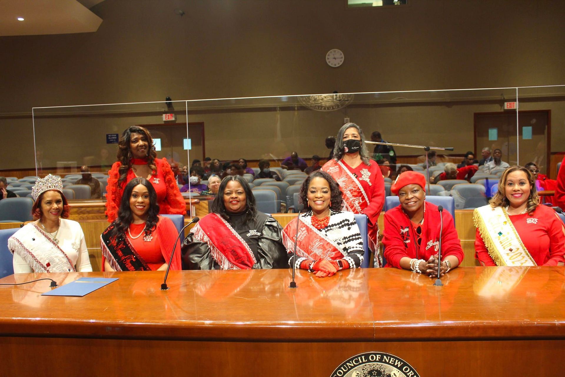 A group of women are sitting at a table in a room.