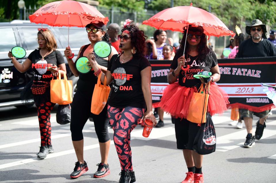 A group of women are walking down the street holding umbrellas.