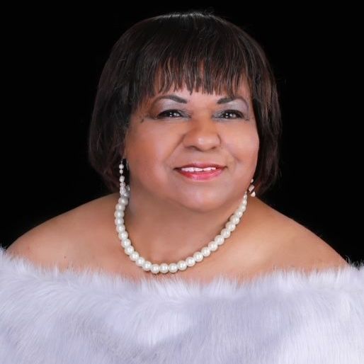 A woman wearing a fur coat and a pearl necklace