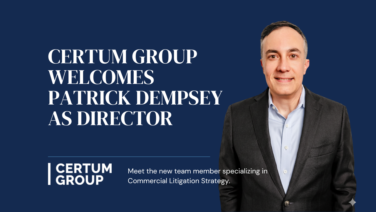 Certum Group welcomes Patrick Dempsey as Director. Man in suit smiles, blue background.
