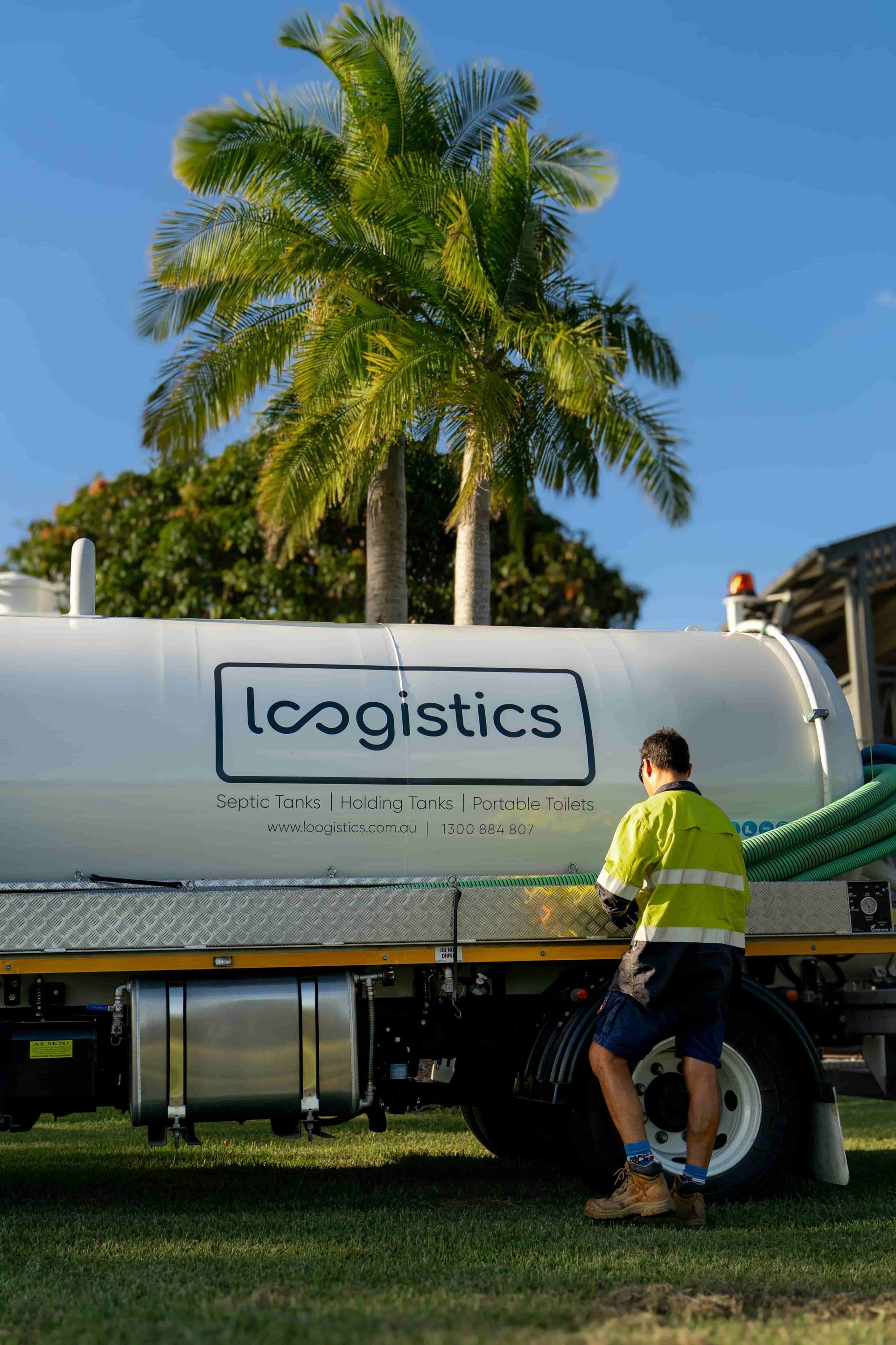 A man is standing next to a large white truck. — Loogistics in Coolum Beach, QLD