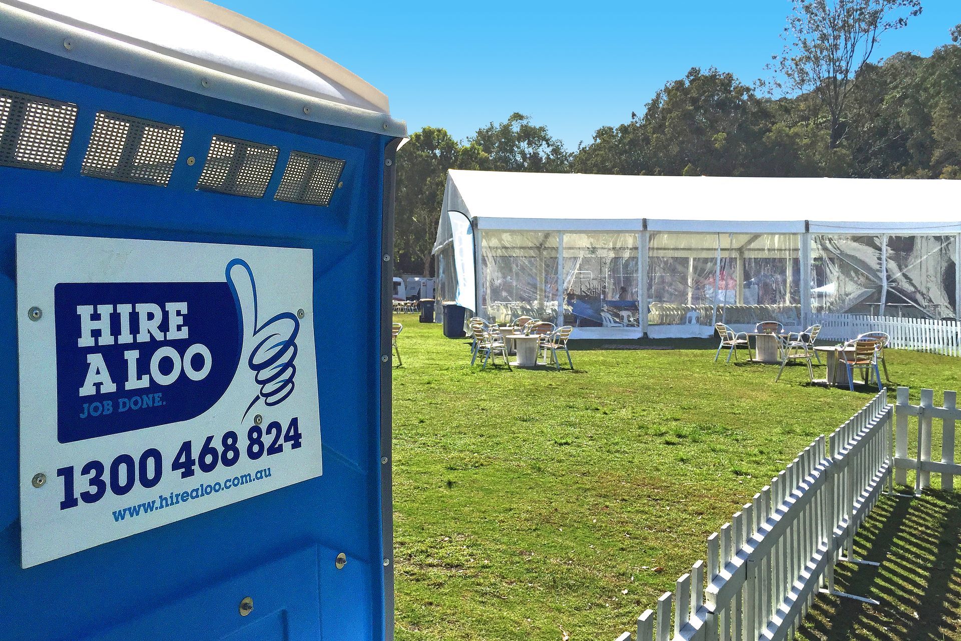 A Portable Toilet is Sitting in the Middle of a Field — Loogistics in Noosa, QLD
