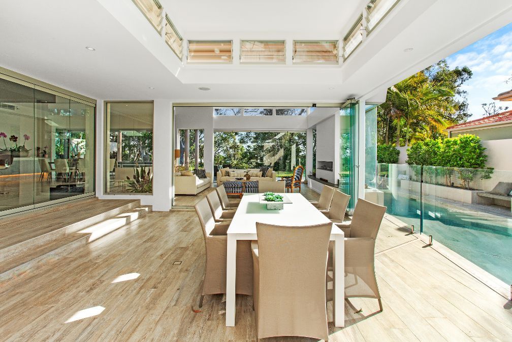 An Elevator With Sliding Glass Doors Leading to a Garden — Paul Cooper Homes In Noosa Heads, QLD
