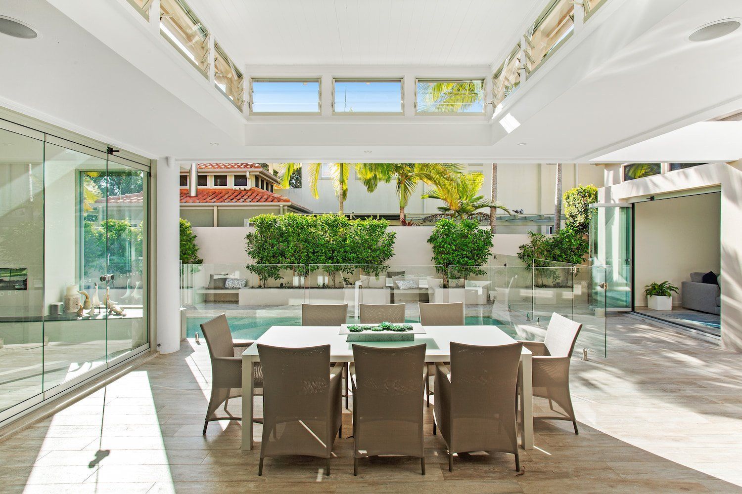 A Kitchen With a Table and Chairs and a Television on the Wall โ Paul Cooper Homes In Noosa Heads, QLD