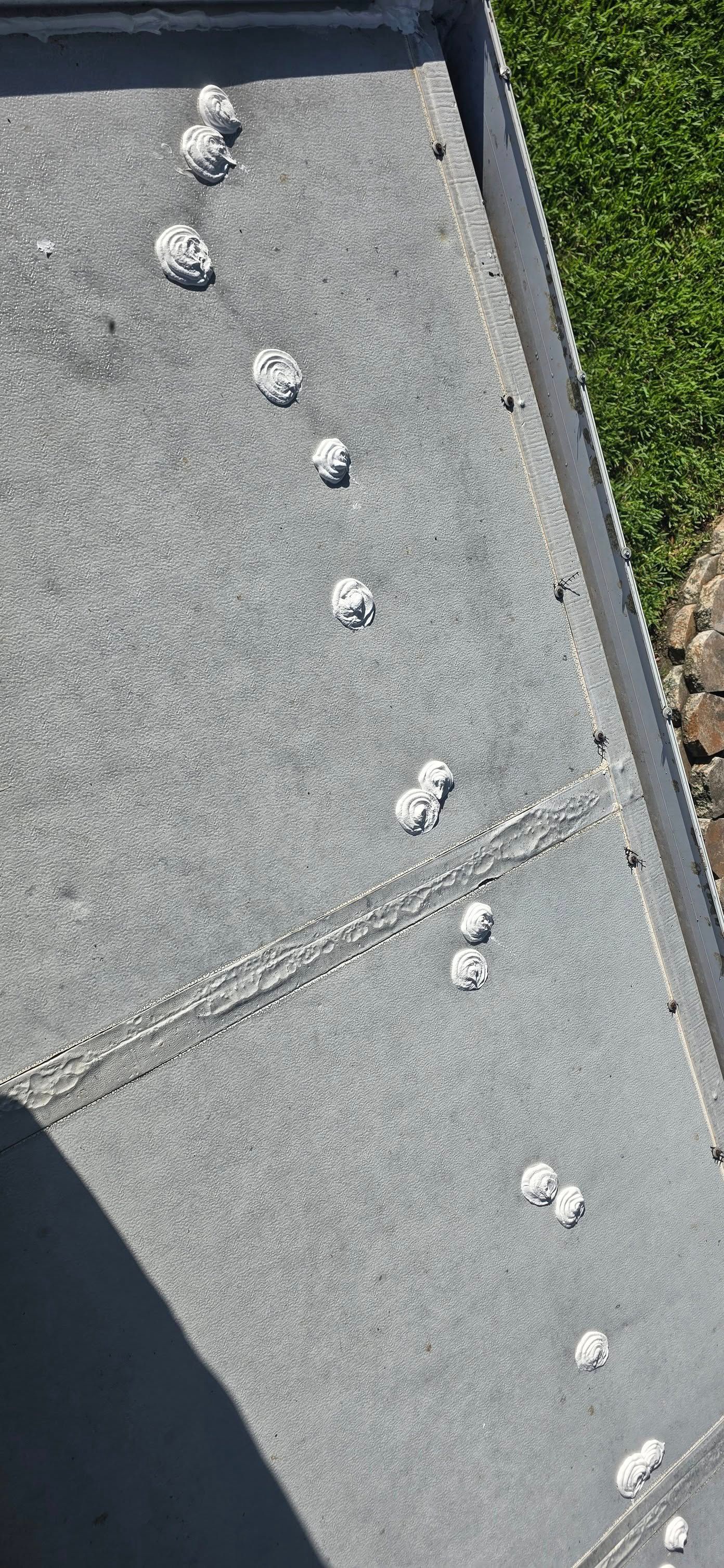 A bunch of white balls are sitting on top of a concrete surface.