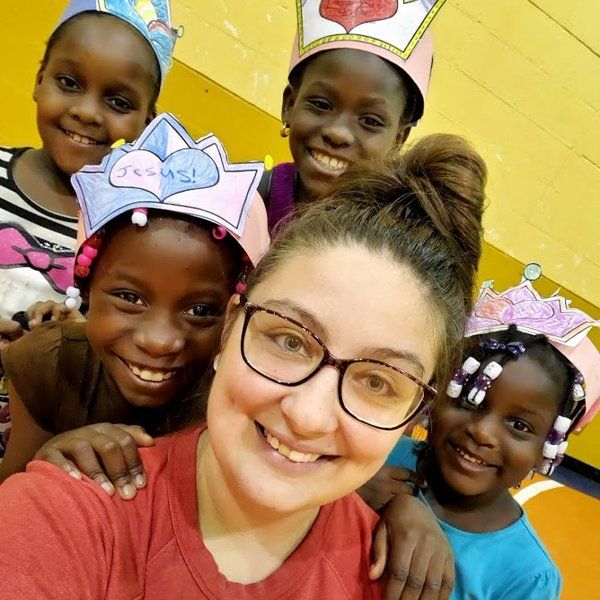 A group of girls smiling with a woman