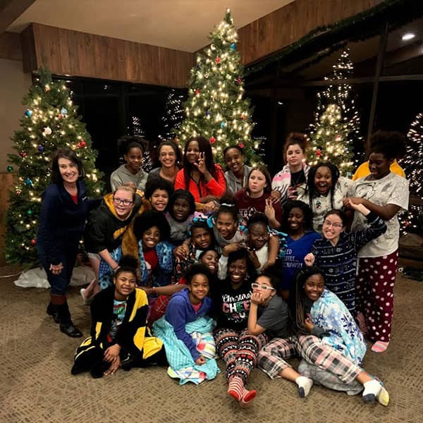 Youths in front of Christmas trees