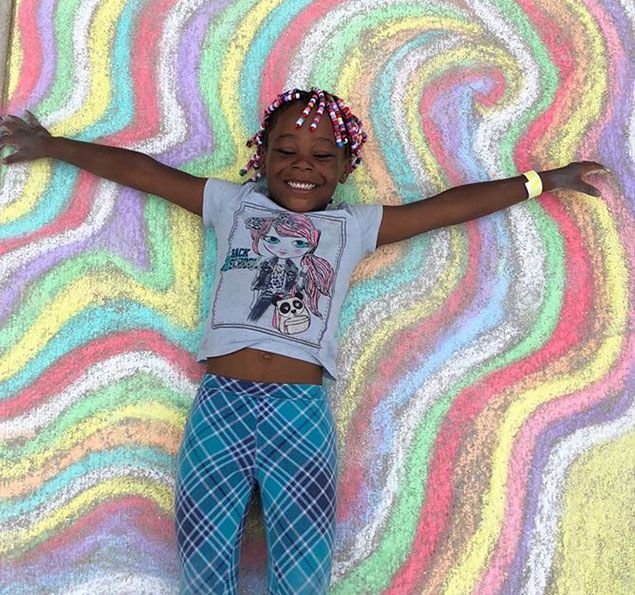 Girl laying on chalk drawing