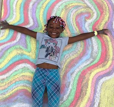 Girl laying on chalk drawing