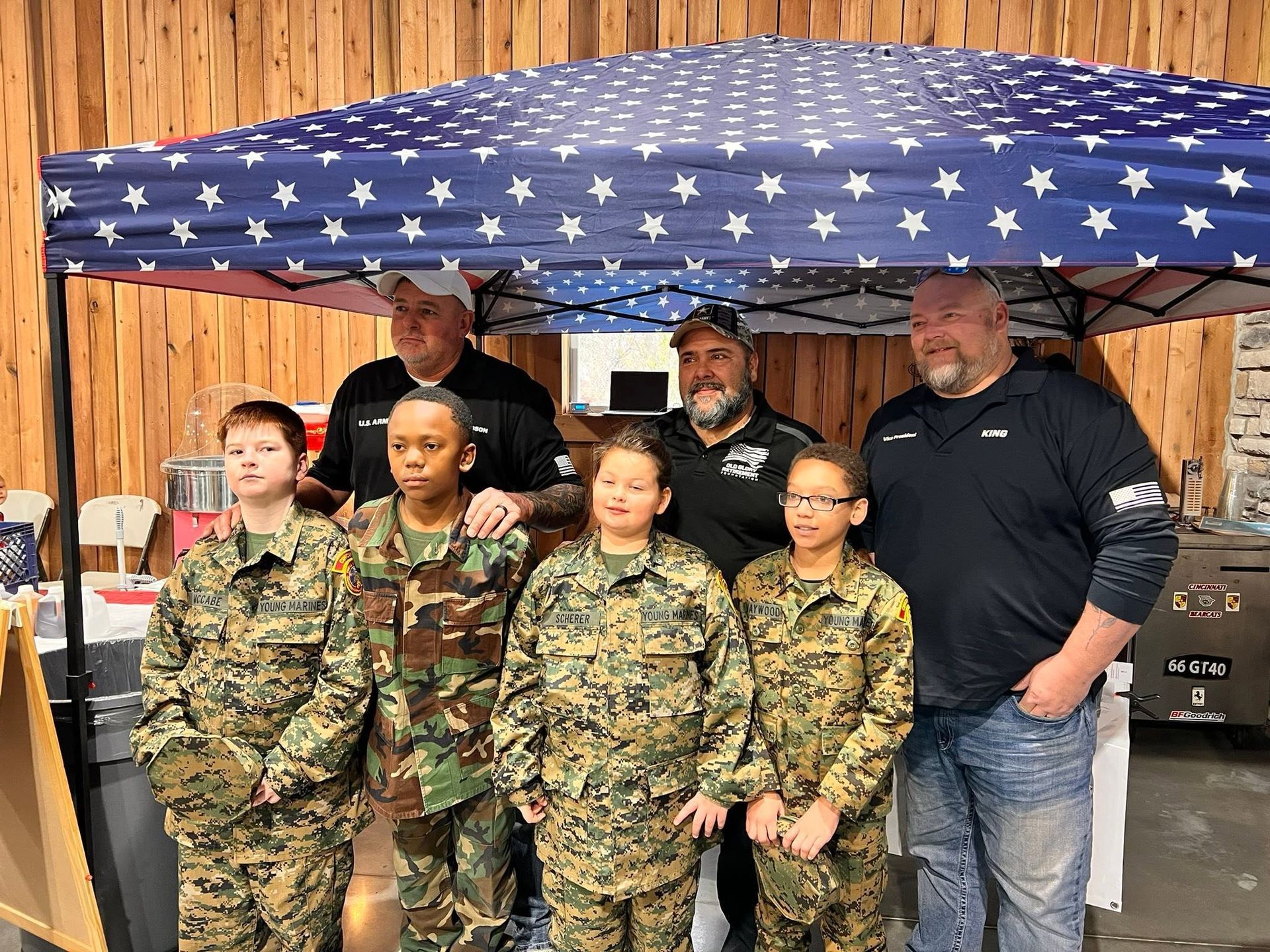 Families and veterans gathered at an outdoor flag retirement ceremony