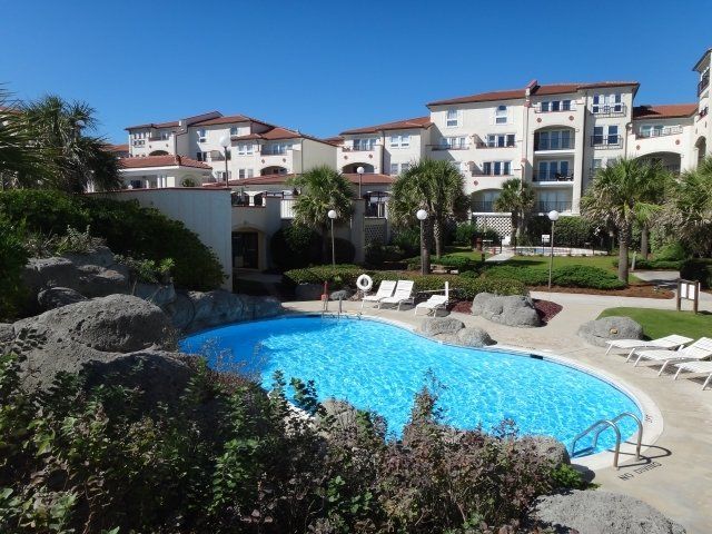 A large swimming pool in front of a large building