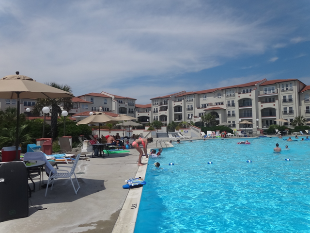 A large swimming pool with a large building in the background