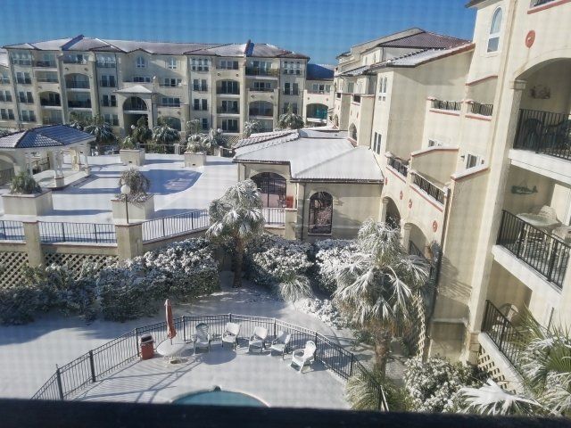 A large building with a swimming pool in the middle of it
