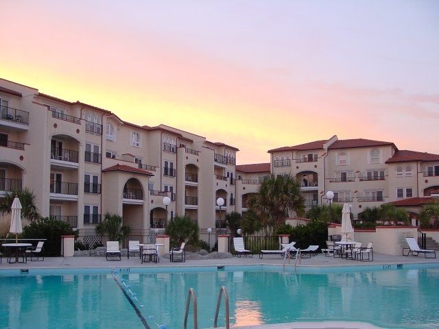 A large building with a swimming pool in front of it