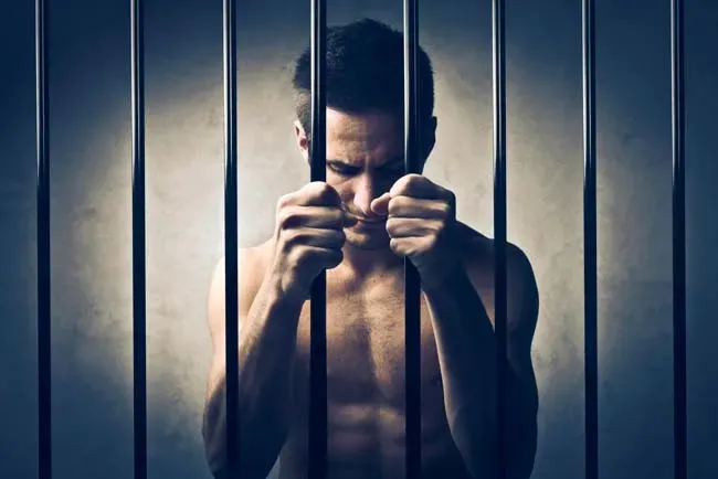 Sad prisoner behind bars — San Antonio, TX — A-Action Bail Bonds Sad prisoner behind bars — San Antonio, TX — A-Action Bail Bonds
