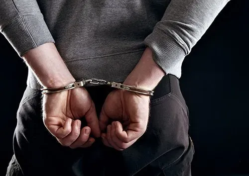 Handcuffed hands of a man — San Antonio, TX — A-Action Bail Bonds Handcuffed hands of a man — San Antonio, TX — A-Action Bail Bonds