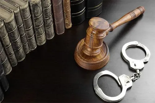Judges gavel, handcuffs and old book on the black table — San Antonio, TX — A-Action Bail Bonds Judges gavel, handcuffs and old book on the black table — San Antonio, TX — A-Action Bail Bonds