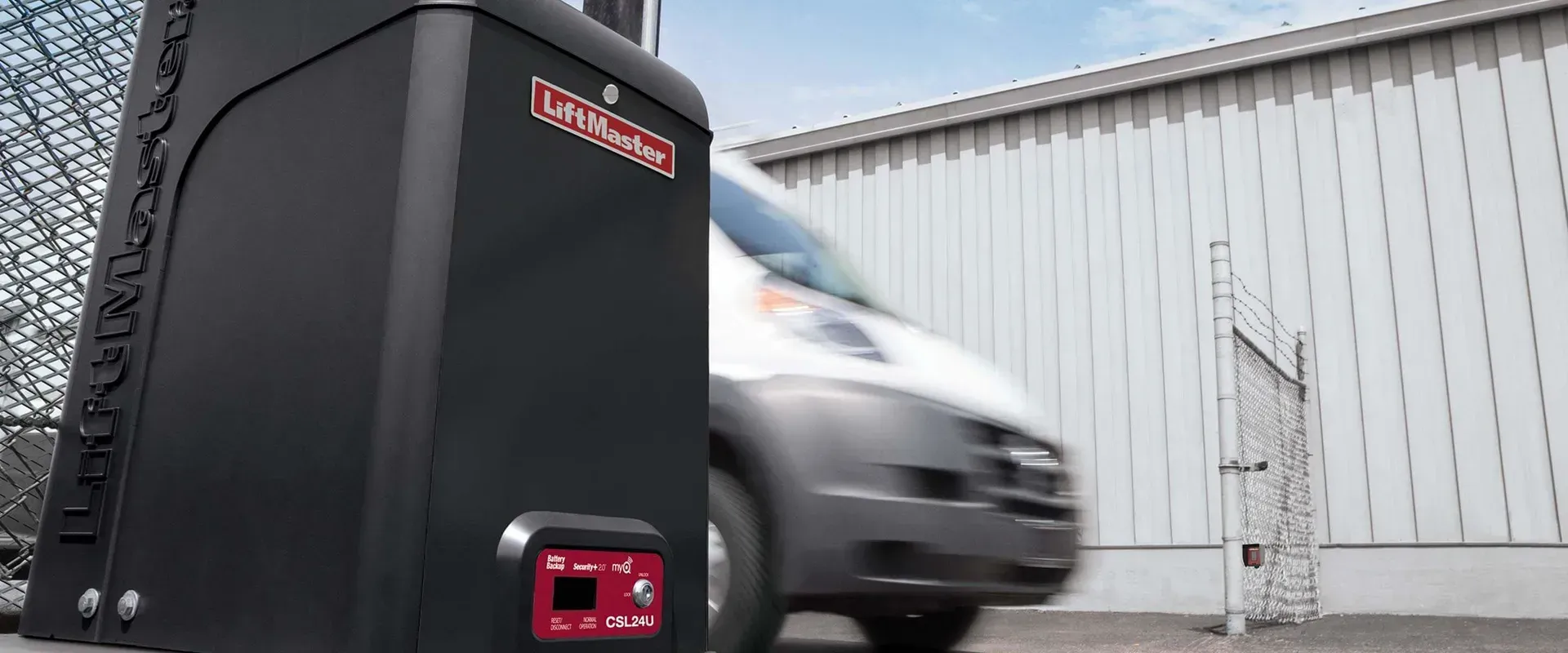 a van beside the electric gate controler with the logo of Liftmonster