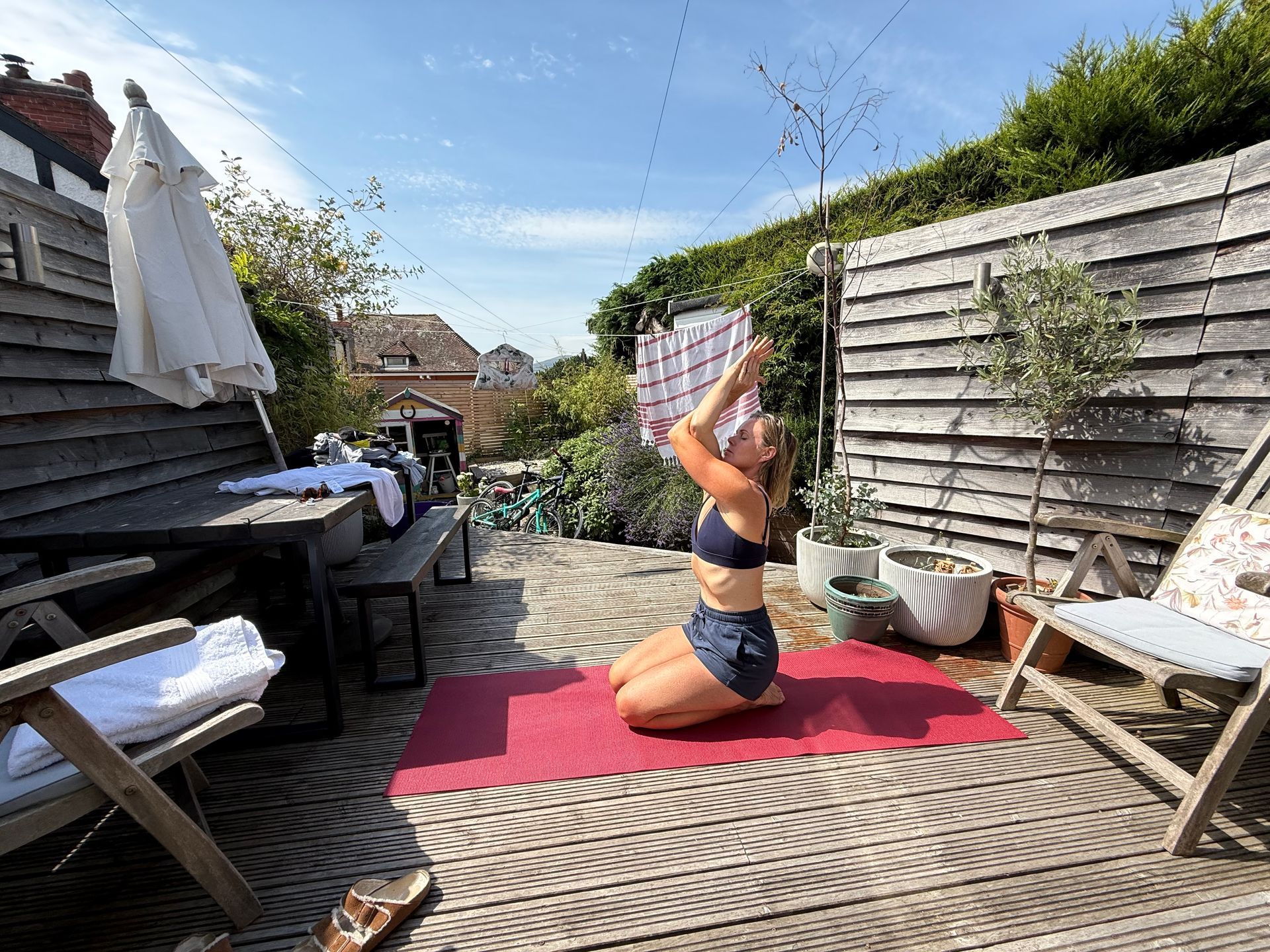 woman doing yoga in a garden on deck