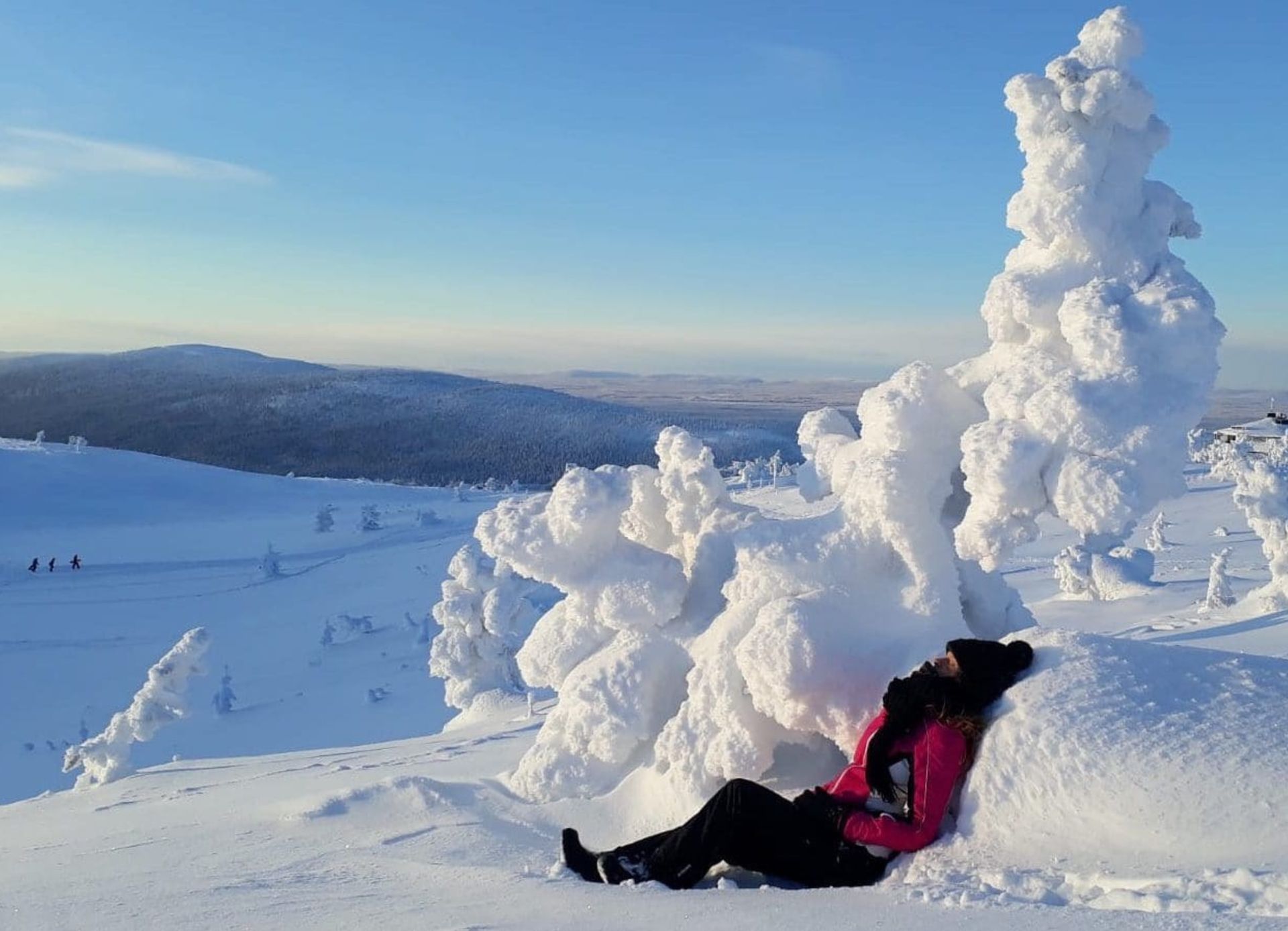 A person sitting up against a snowdrift