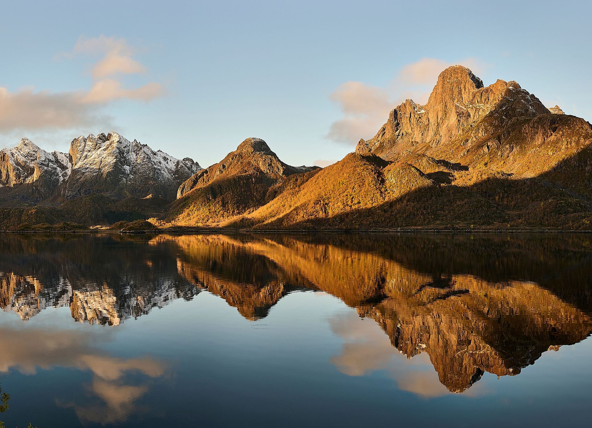 Mountains reflected in a still fjord, northern Norway