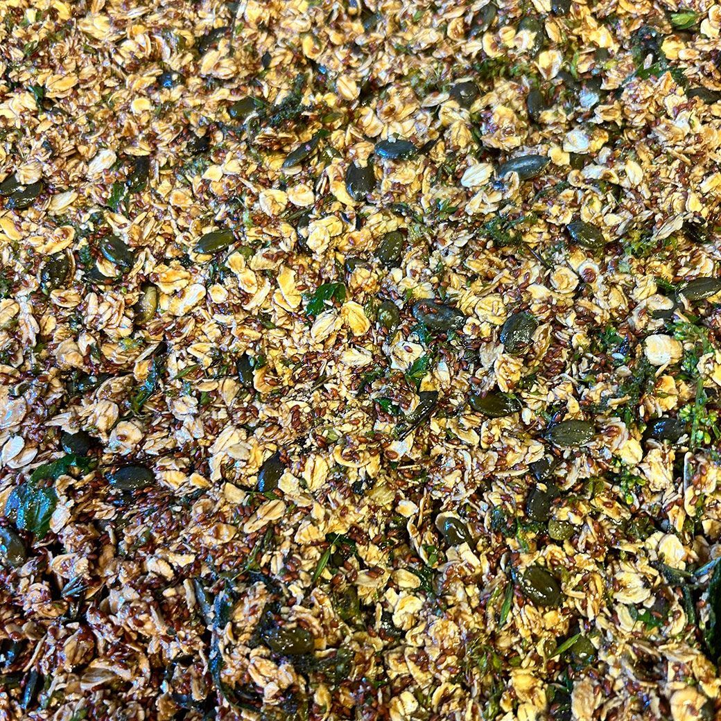 Close-up of baked granola with oats, seeds, and nuts.