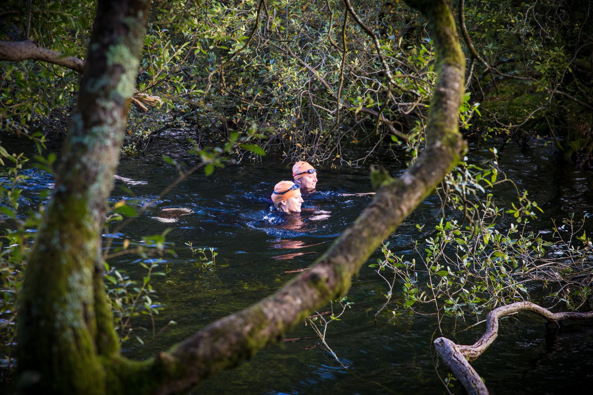 Two ladies swimming in a lake