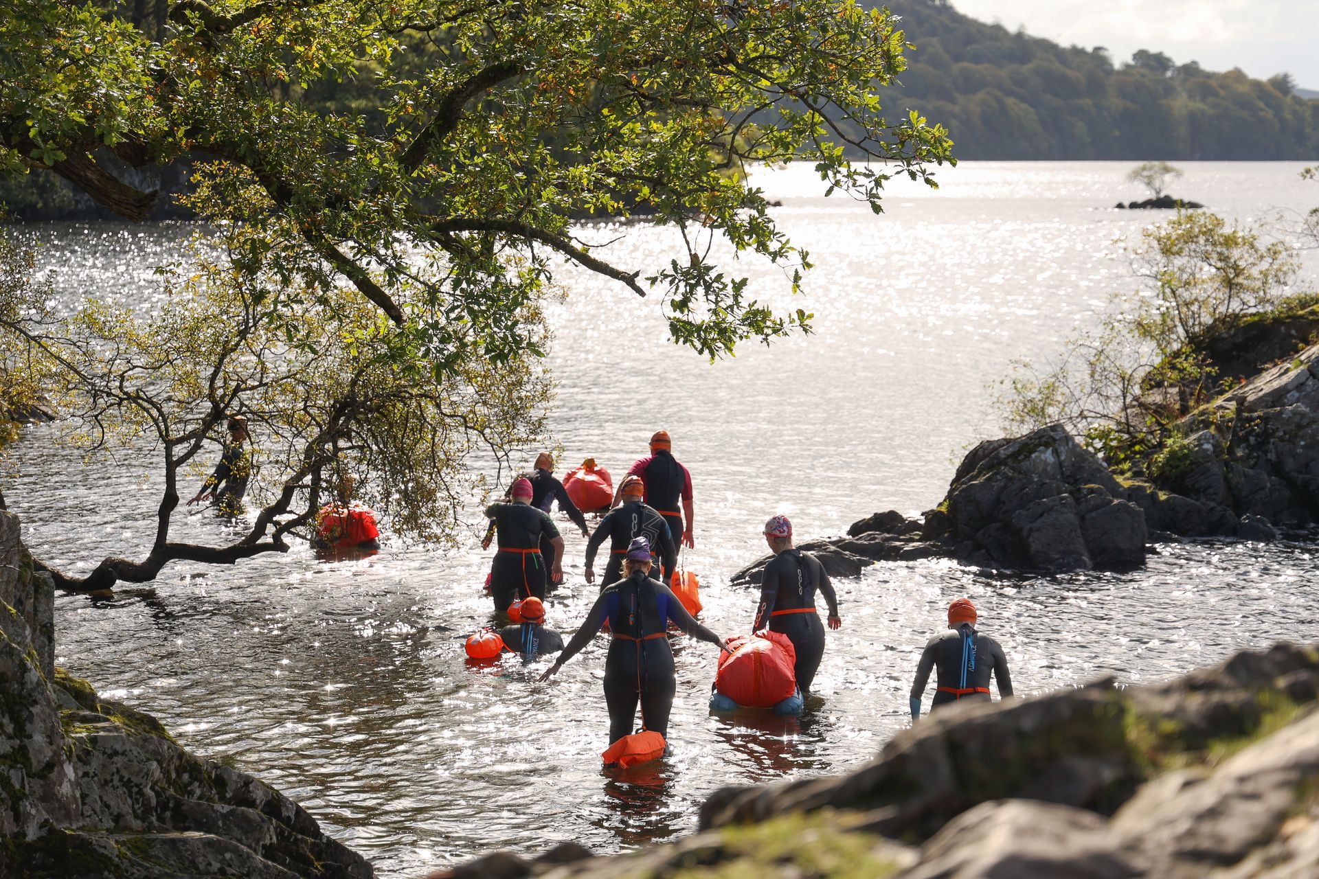 People walking into the water for a swim