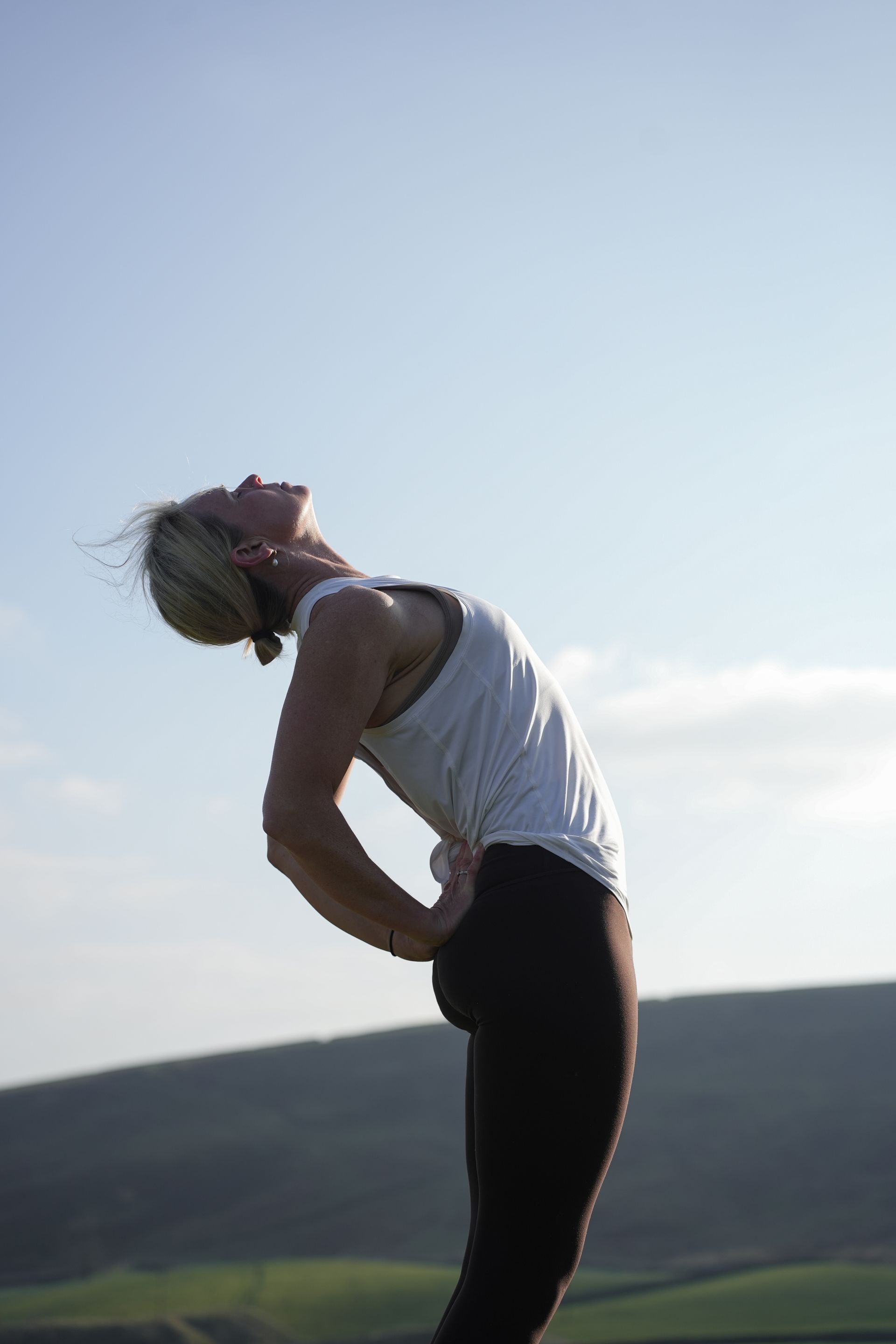 A lady doing yoga outside