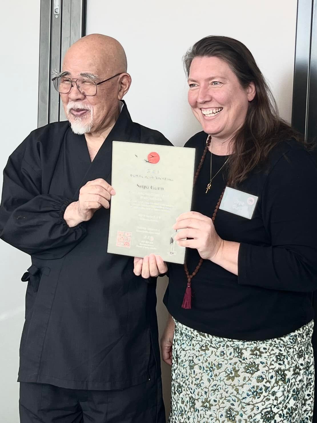 Reiki Master Sirpa Gunn receiving a certificate from Hyakuten Inamoto on completion of KonyoDo Reiki training