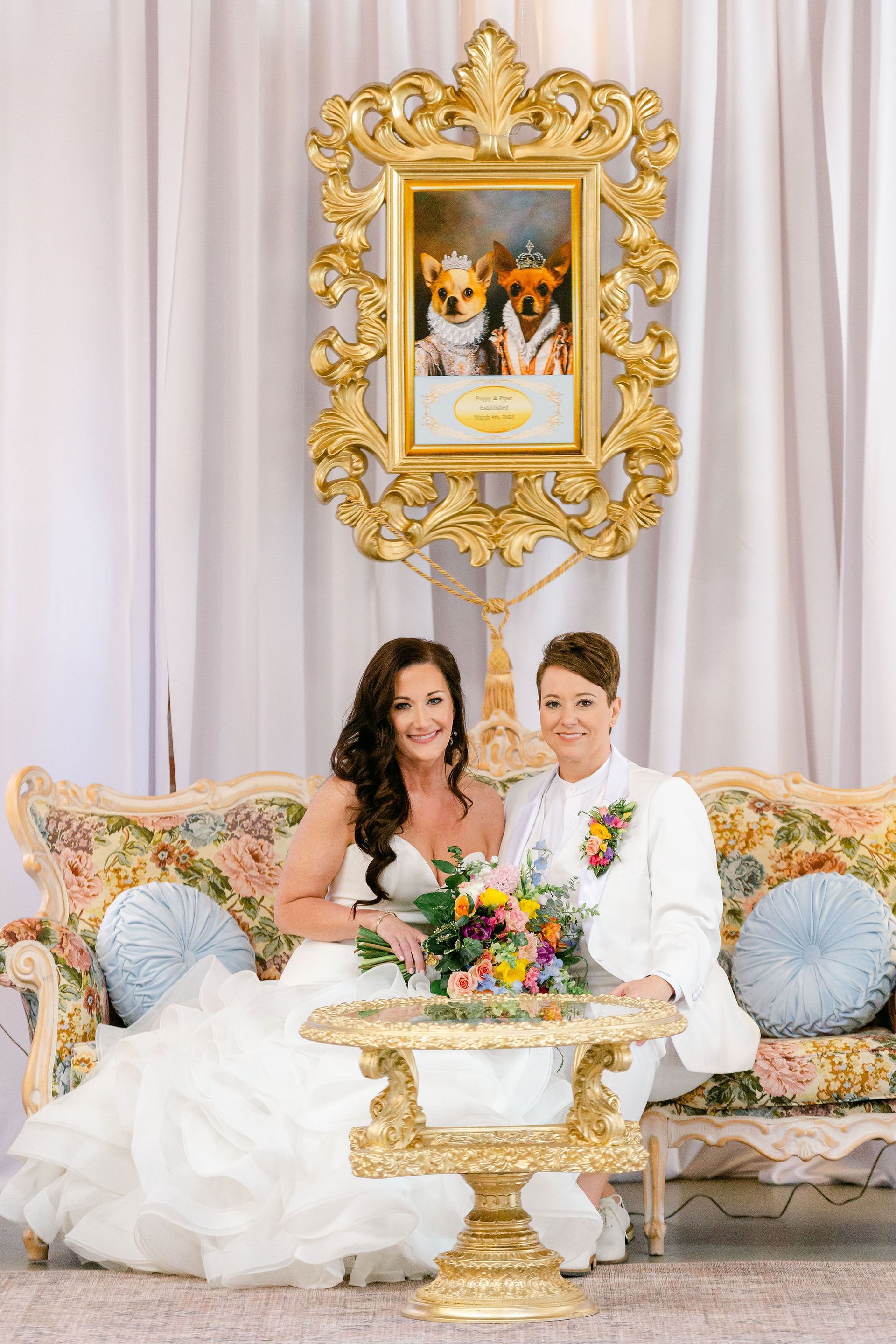 portrait of couple's dogs in gold frame at wedding