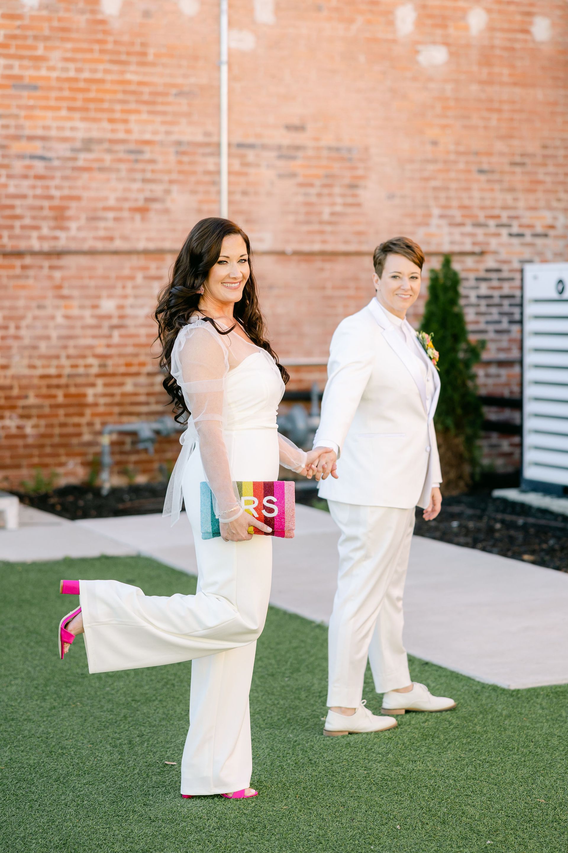 same sex brides holding hands
