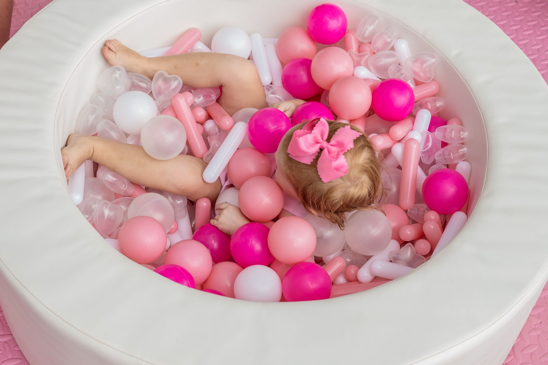 little girl in pink ball pit for party