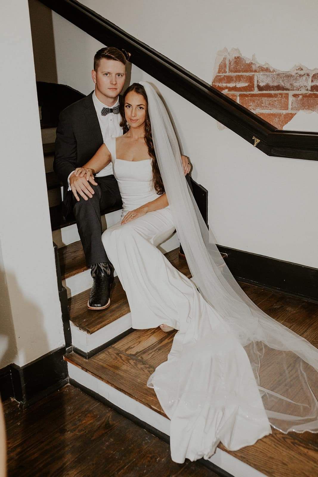 bride and groom embracing on stairwell