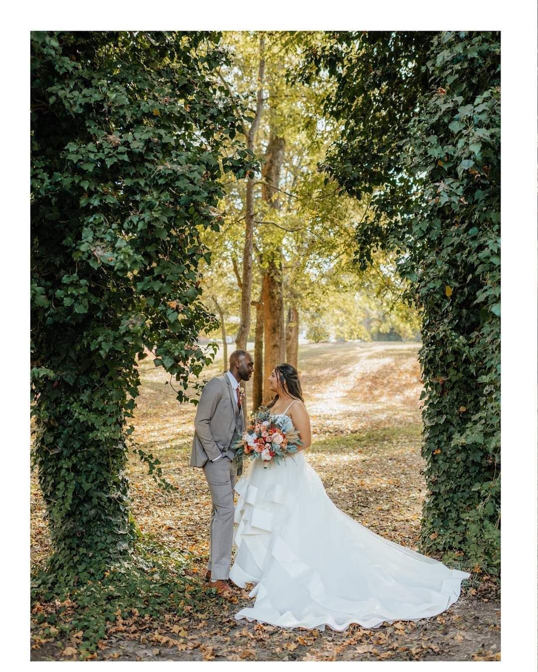 bride and groom surrounded by ivy