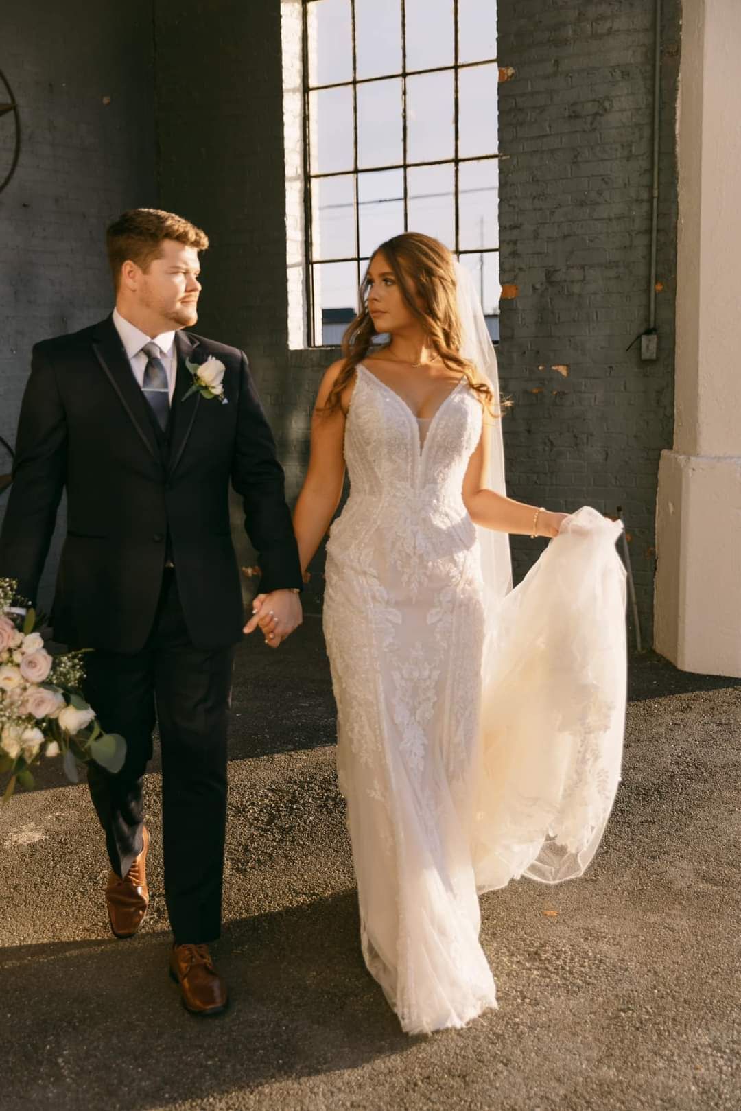 bride and groom holding hands and walking together