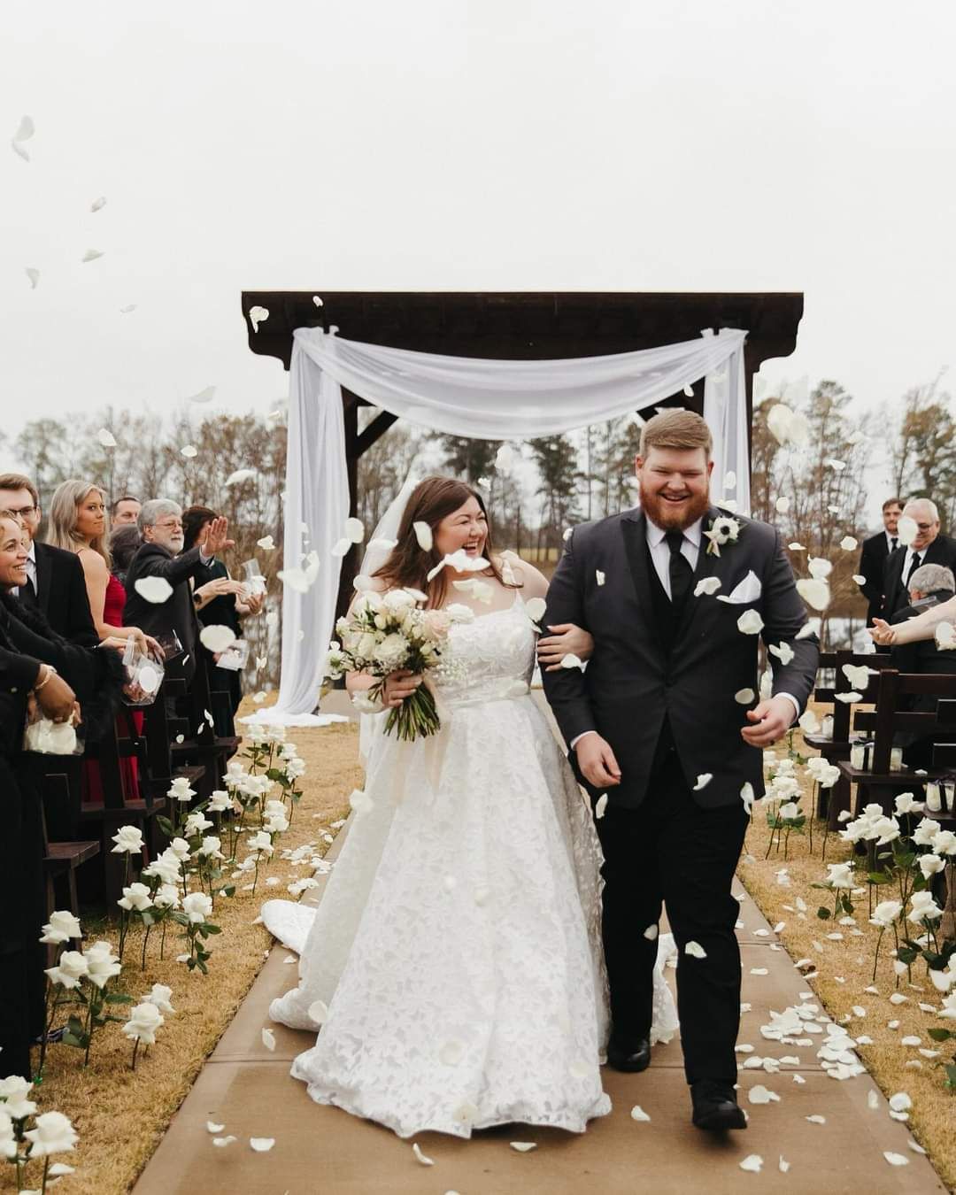 couple walking down the aisle after outdoor wedding ceremony