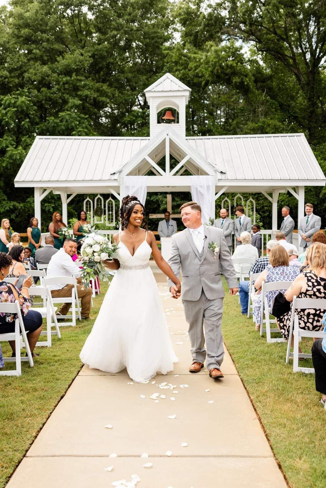 bride and groom walking down aisle after outdoor wedding ceremony
