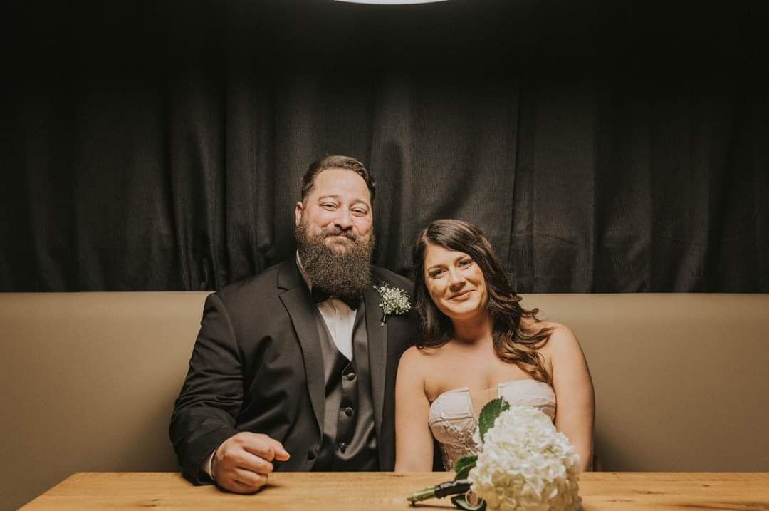 bride and groom sitting in restaurant booth