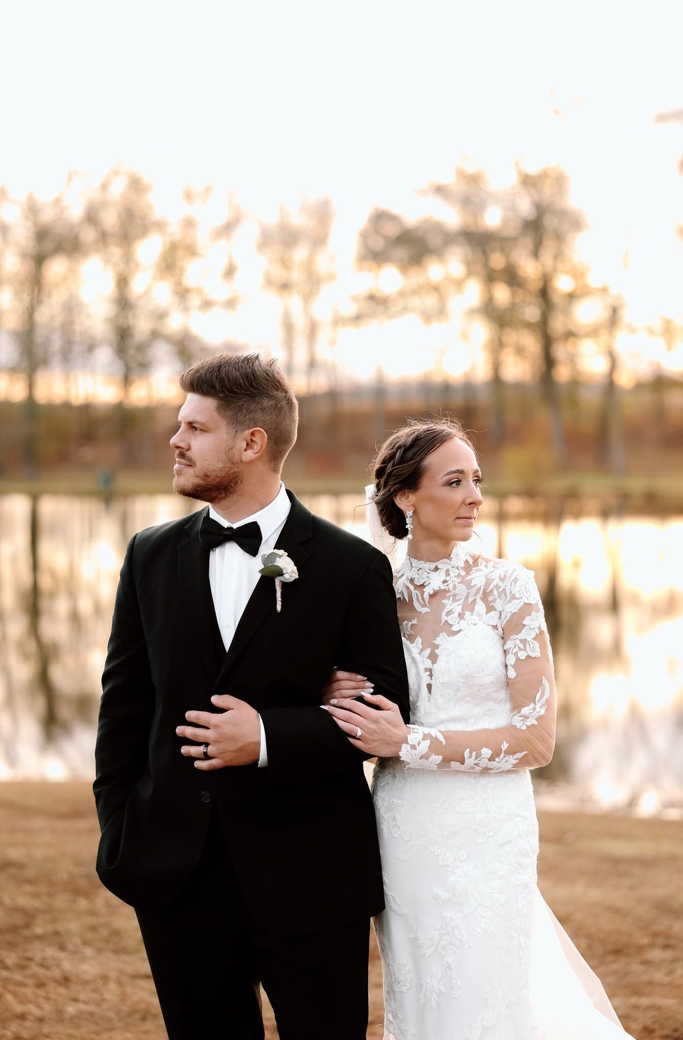 bride and groom embracing at sunset
