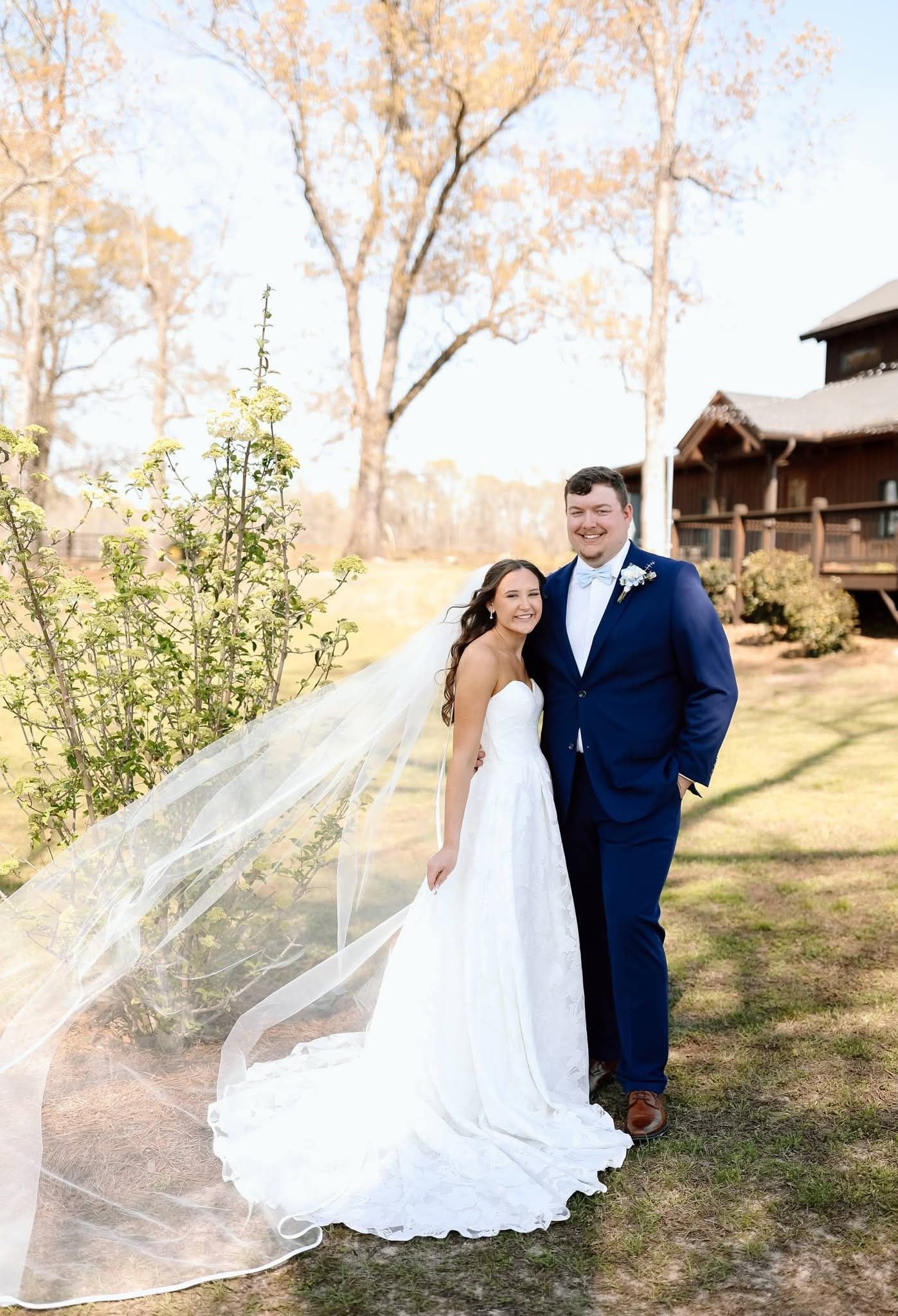 bride and groom smiling outside venue