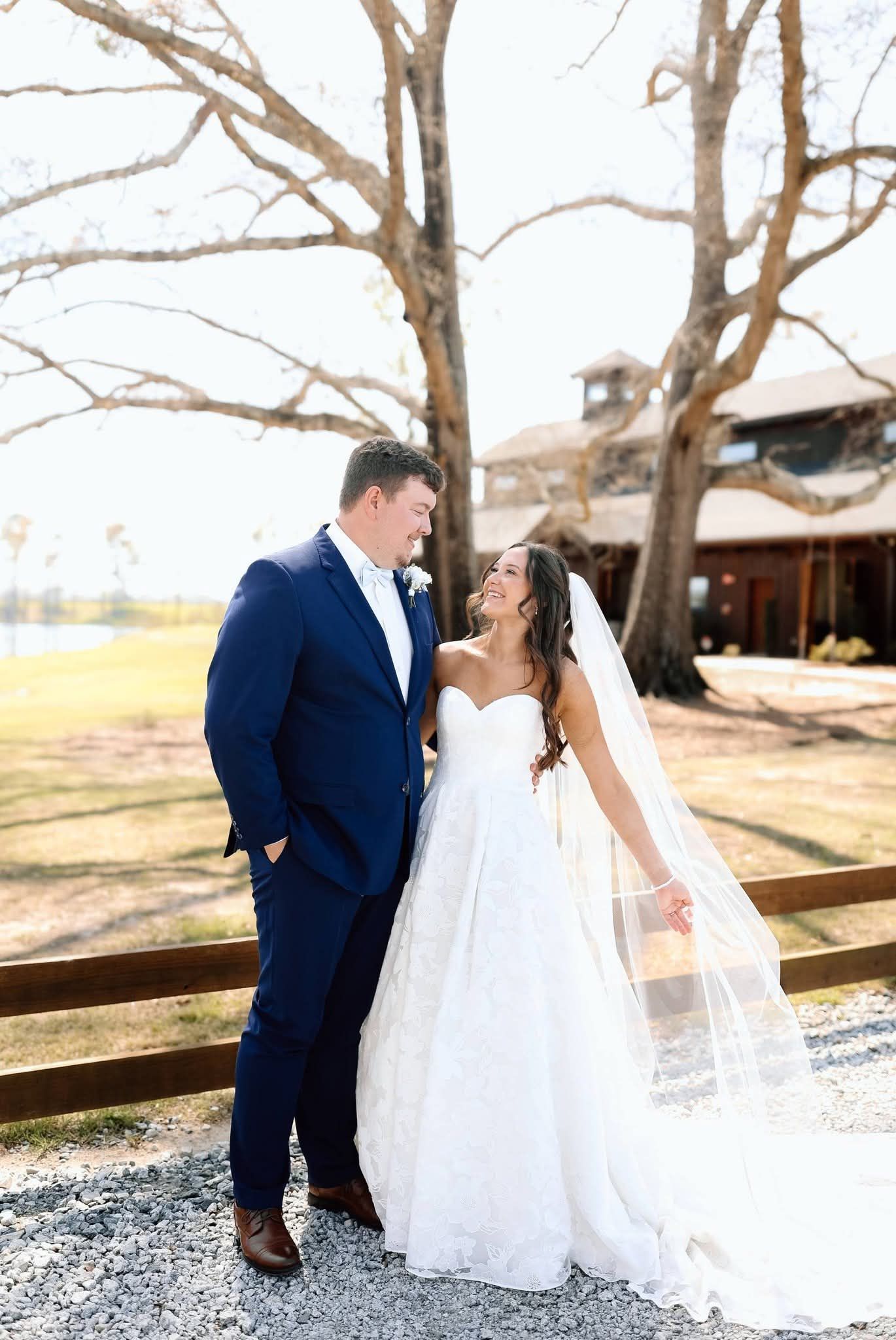 bride and groom smiling at each other