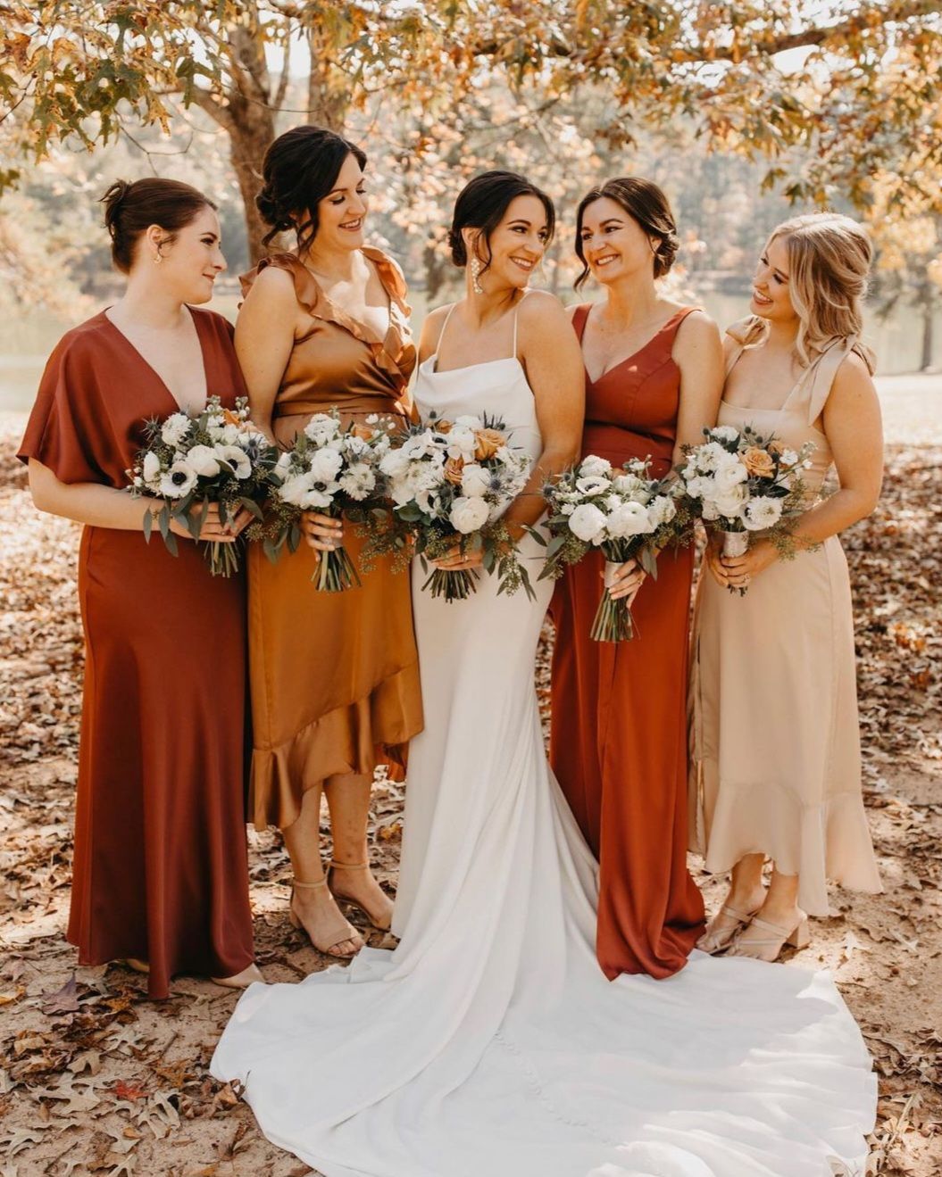 bride with bridesmaids in rust colored dresses