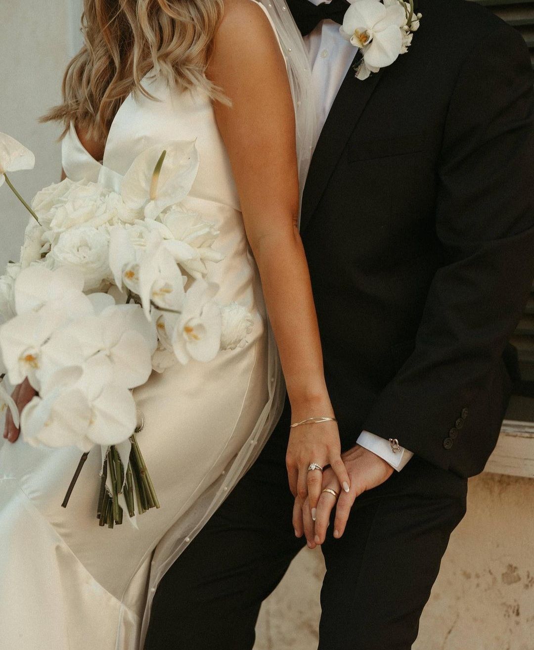 bride and groom holding hands