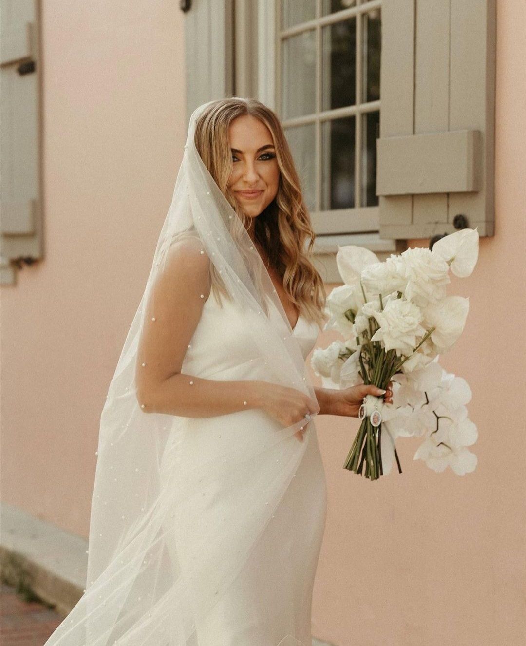 bride in pearl studded veil